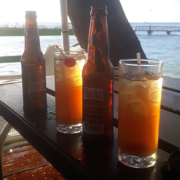 bottles of beer on a table by the seaside